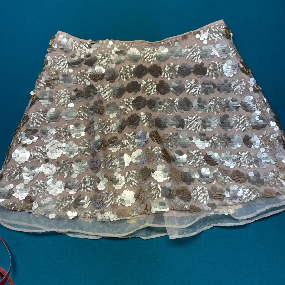 Rose gold color sequin mini skirt.
